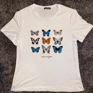 White shirt with flower design and saying wild and free